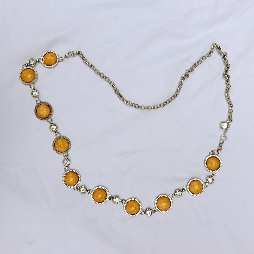 silver and orange waist belt